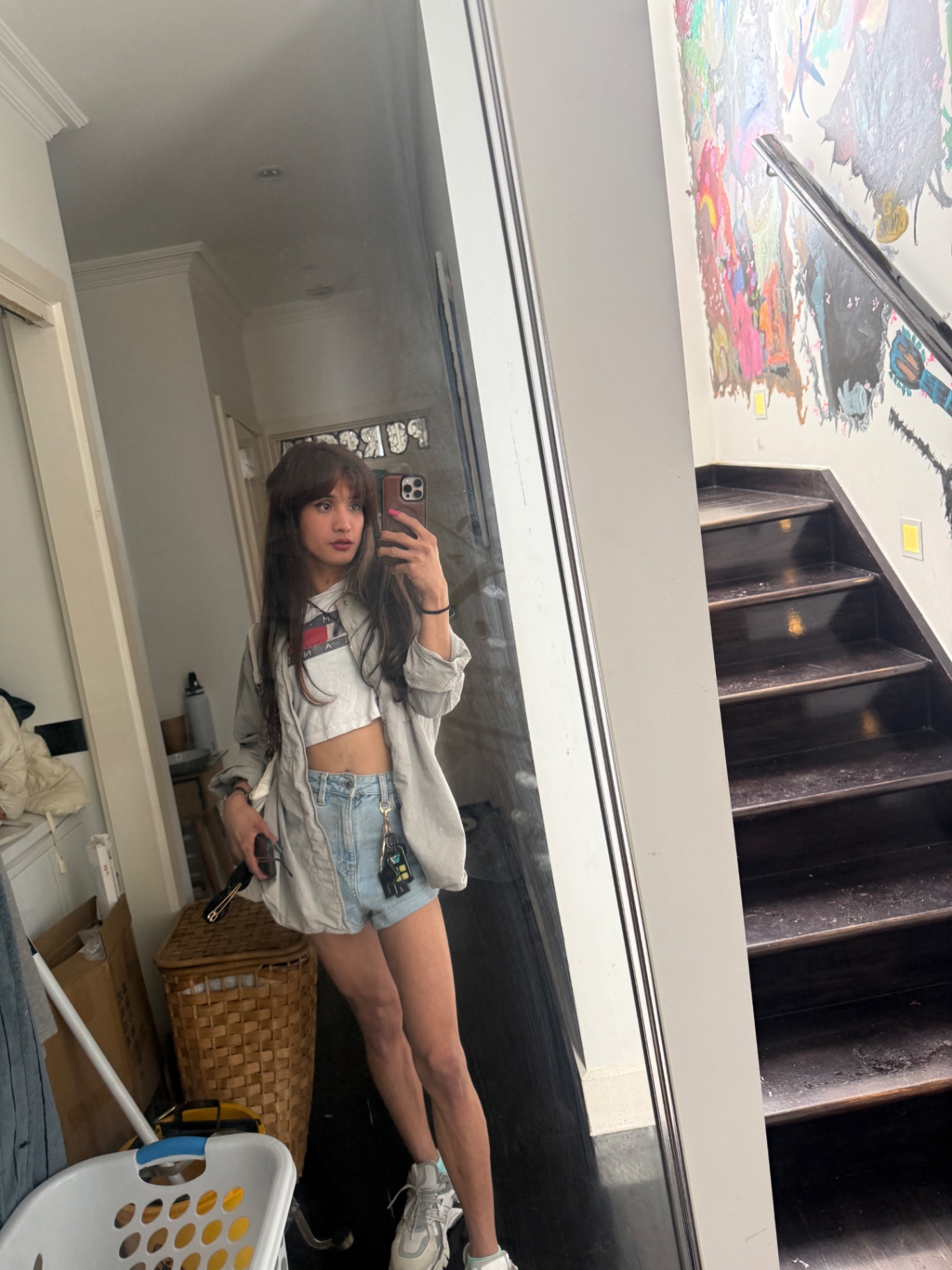 POR$CHA in white cropped jacket and denim shorts, mirror self-portrait