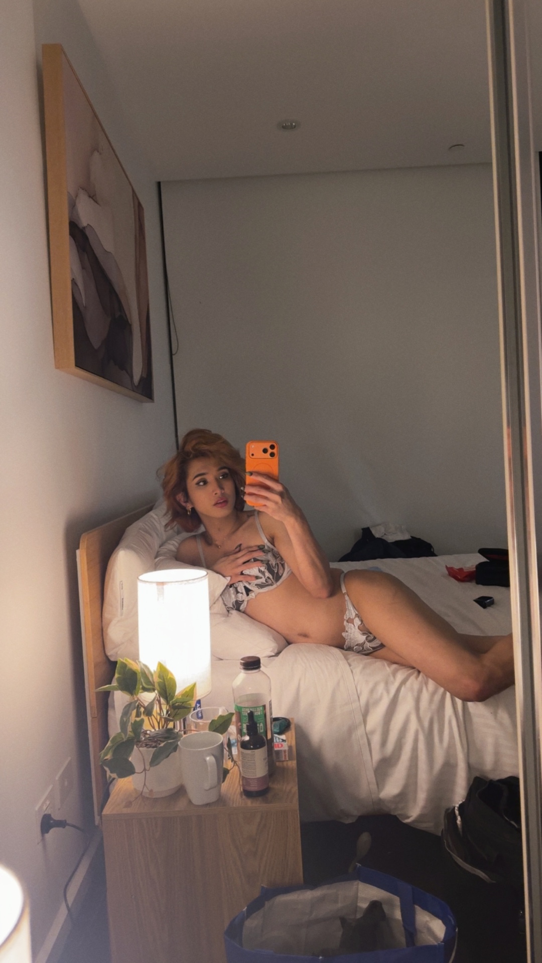 POR$CHA in lingerie beside a lamp, intimate mirror self-portrait