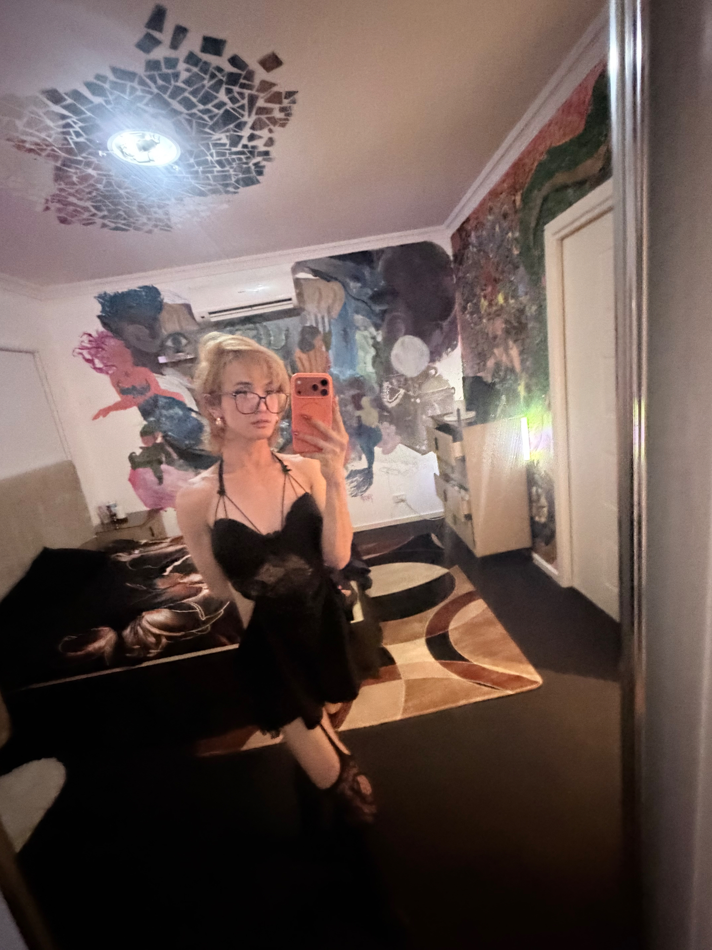 POR$CHA in black with glasses, artistic mural room mirror self-portrait
