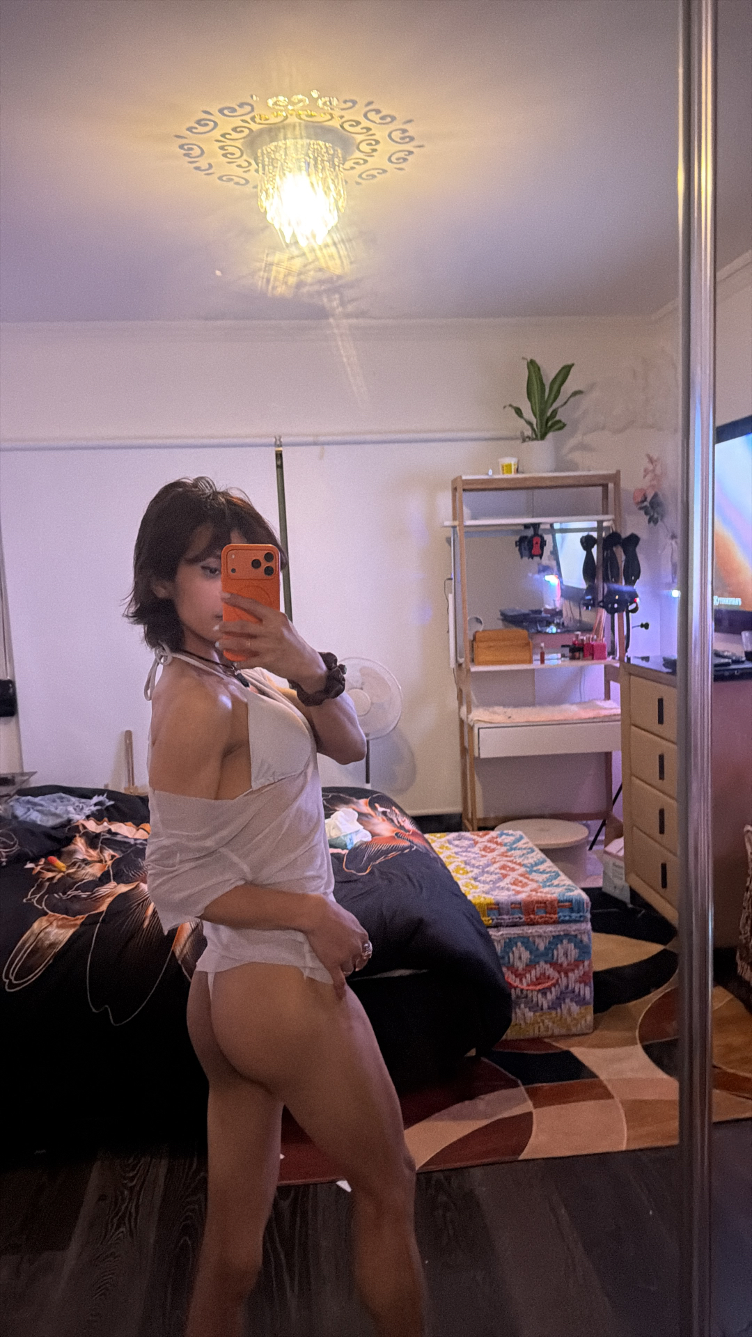 POR$CHA in warm lamplight, mirror self-portrait at home